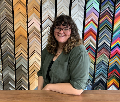 PictureA photo of Hope in front of frame samples.